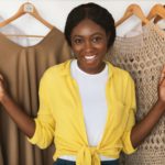 African American Shopaholic Woman Posing Among Clothes In Wardrobe Indoor