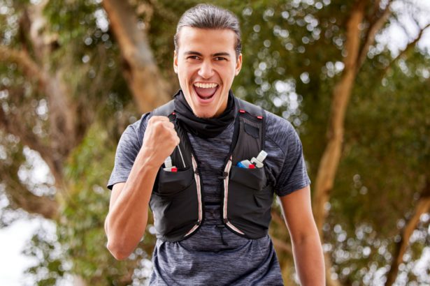 Fitness, man and portrait smile in celebration for winning, achievement or accomplishment in nature
