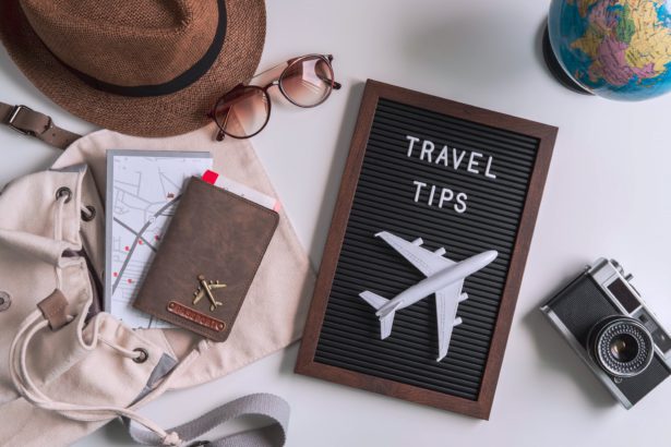 Retro camera with toy plane, map and passport on white background, Travel tips concept